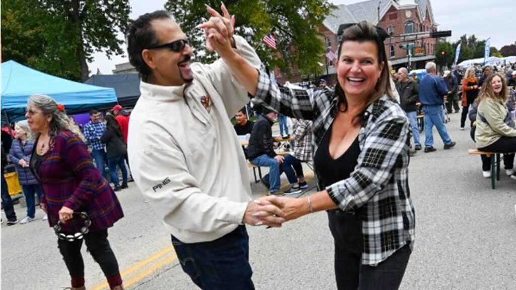 Couple enjoys a Polka dance in the streets of Elkhorn for Oktoberfest.